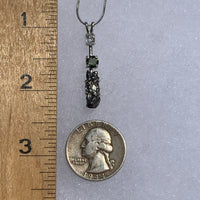 sterling silver pendant necklace with Herkimer diamond, moldavite, and campo del cielo meteorite next to a ruler and a US quarter for scale
