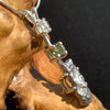 sterling silver pendant necklace with Herkimer diamond, moldavite, and campo del cielo meteorite sits on driftwood for display