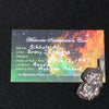A pendant sits on a meteorite identification card