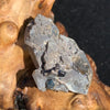Gray quartz cluster with black brookite in matrix displayed on driftwood
