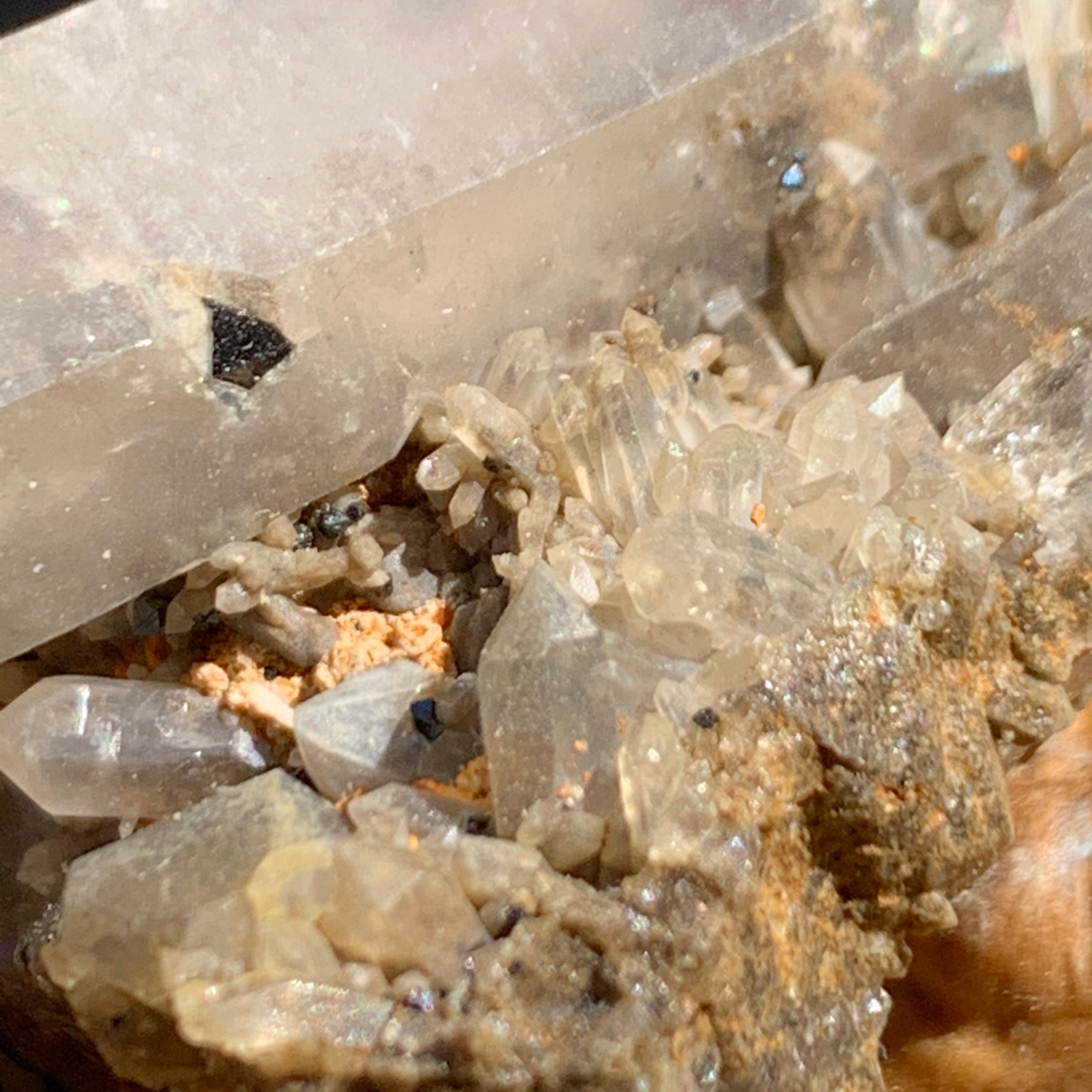 close up view of tiny brookite crystals on a smokey quartz point cluster