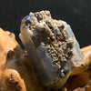 medium, small, and tiny brookite crystals on a smokey quartz cluster sitting on driftwood for display