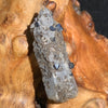 small brookite crystals on a smokey quartz point sitting on driftwood for display