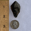 medium and tiny brookite crystals on a smokey quartz point next to a ruler and a quarter for scale