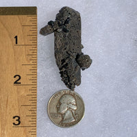 small and tiny brookite crystals on a smokey quartz point cluster next to a ruler and a quarter for scale