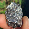 silver campo del cielo meteorite held in hand to show details