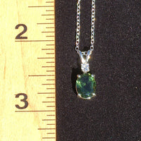 Moldavite and Brazilian phenacite pendant necklace next to ruler to show scale