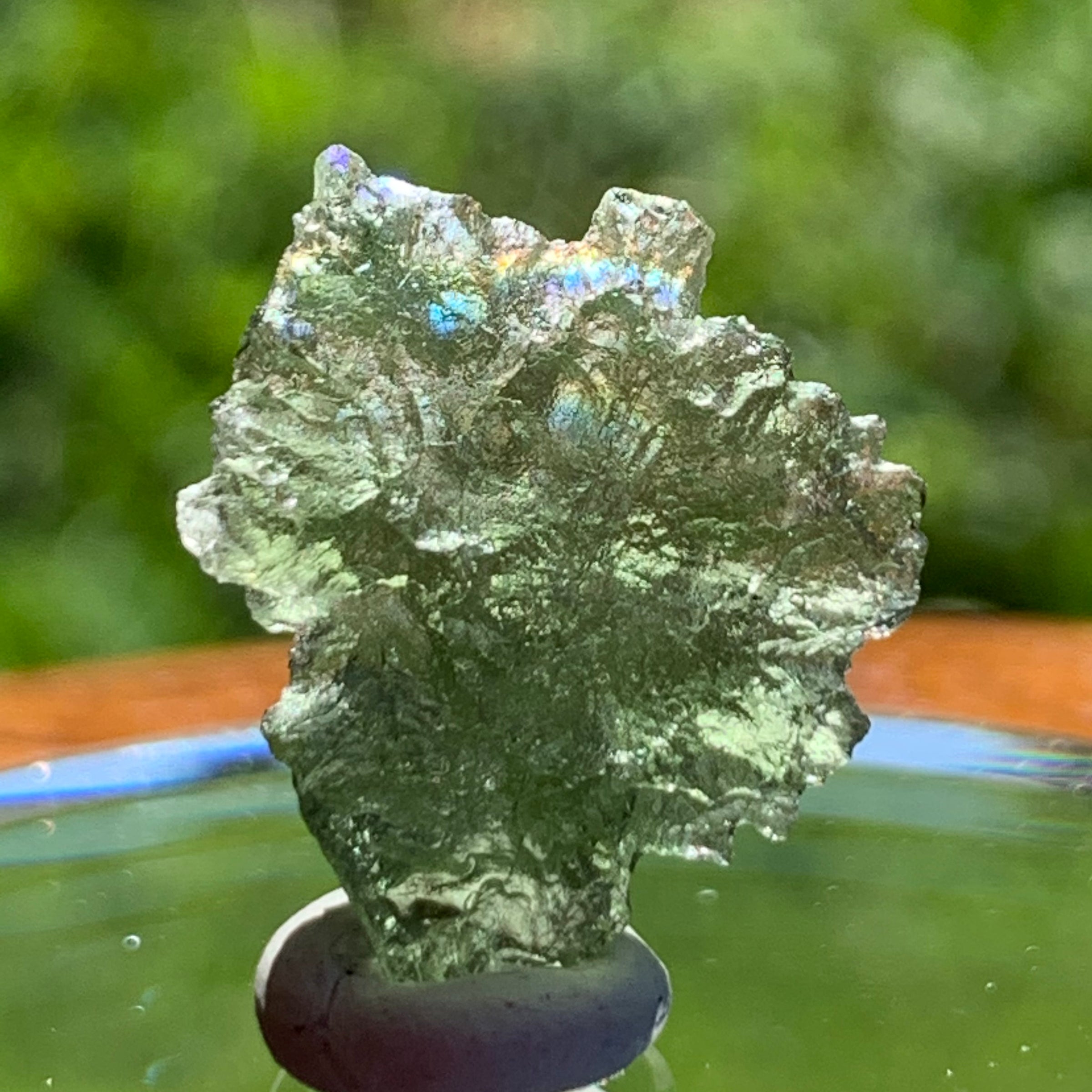 thin green besednice moldavite tektite on display