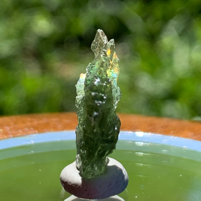 thin green besednice moldavite tektite on display