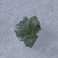 thin green besednice moldavite tektite on display