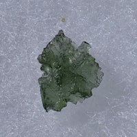 thin green besednice moldavite tektite on display