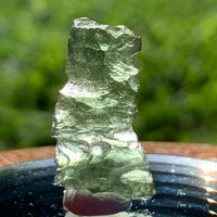 thin green besednice moldavite tektite on display