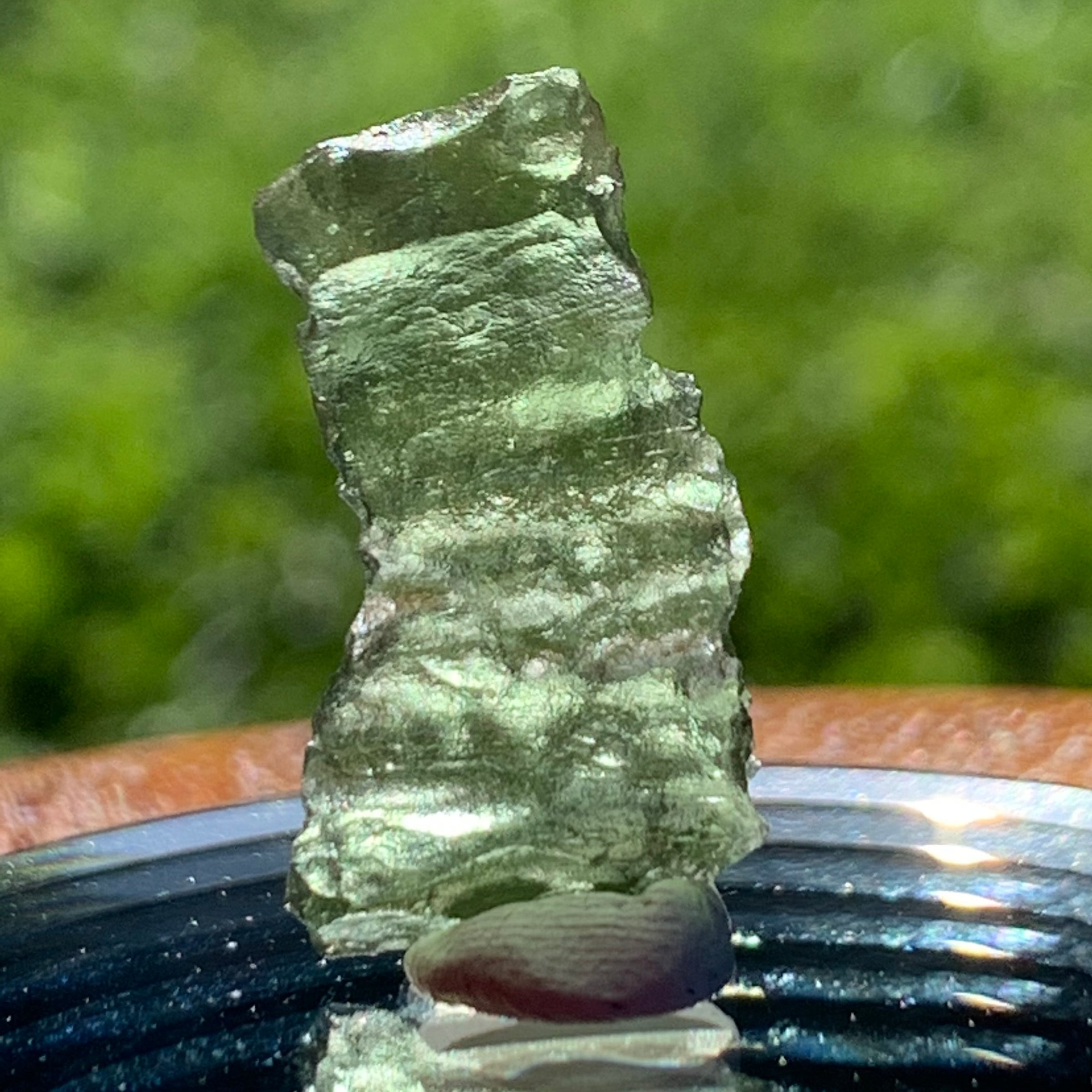 thin green besednice moldavite tektite on display