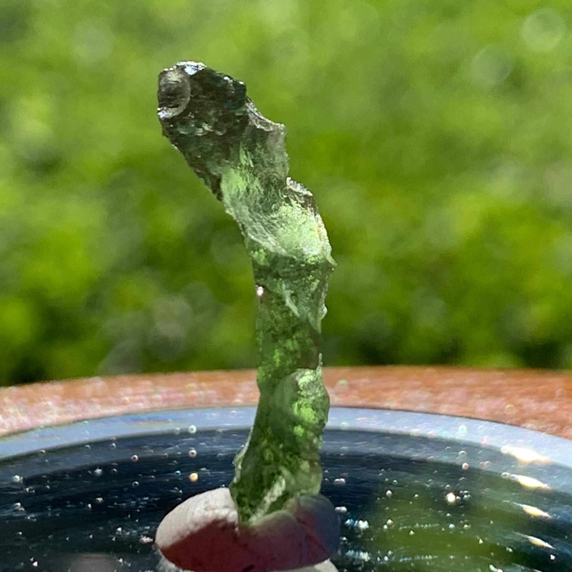 thin green besednice moldavite tektite on display