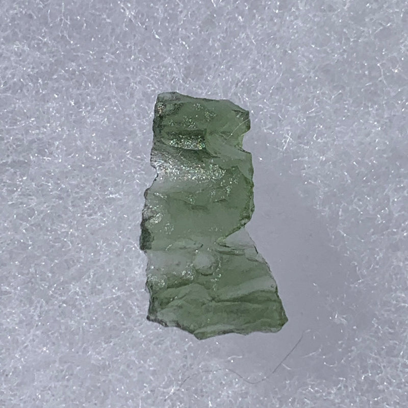 thin green besednice moldavite tektite on display