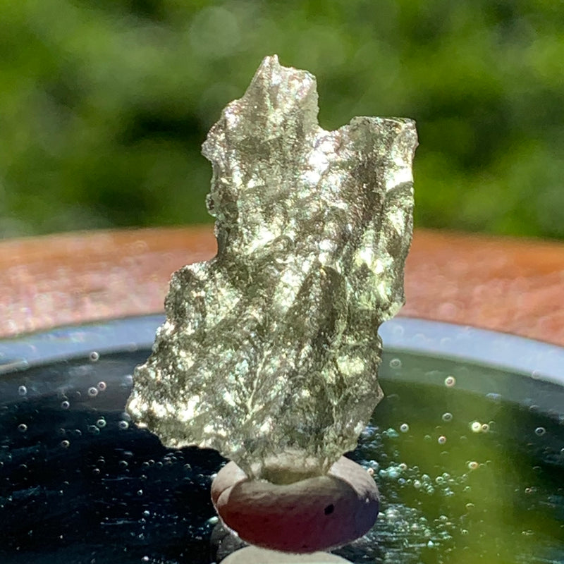 thin green besednice moldavite tektite on display