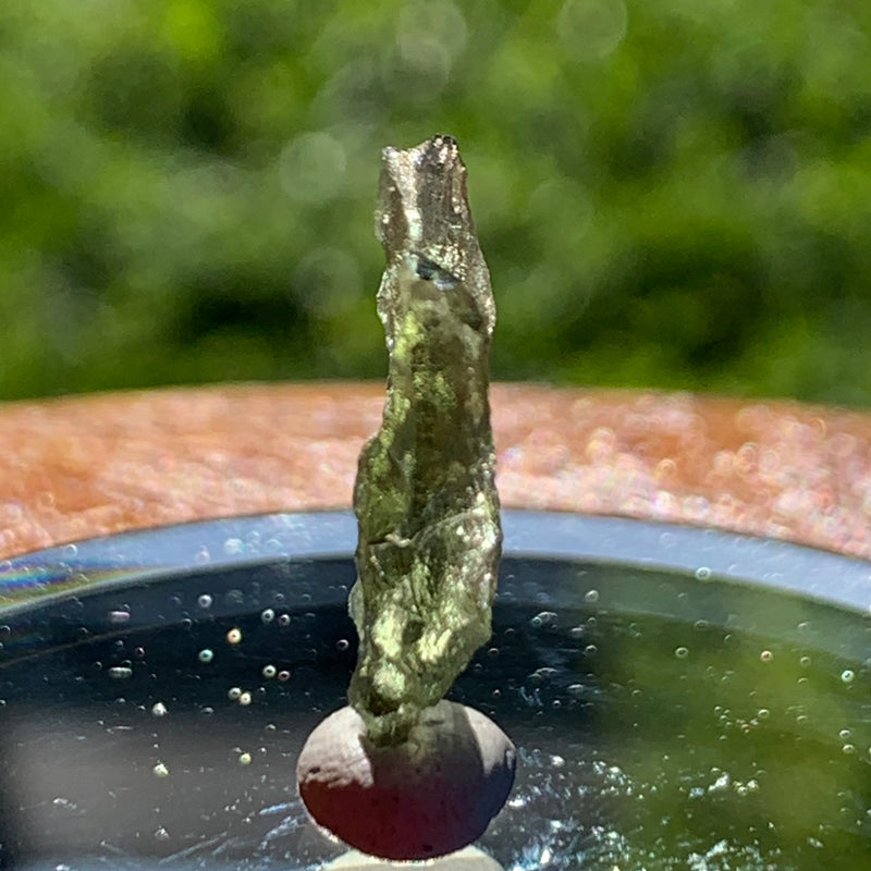 thin green besednice moldavite tektite on display