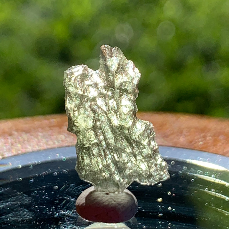 thin green besednice moldavite tektite on display