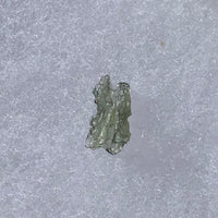 thin green besednice moldavite tektite on display