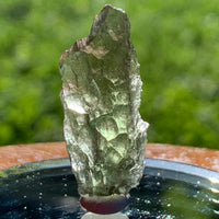 thin green besednice moldavite tektite on display