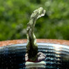 thin green besednice moldavite tektite on display