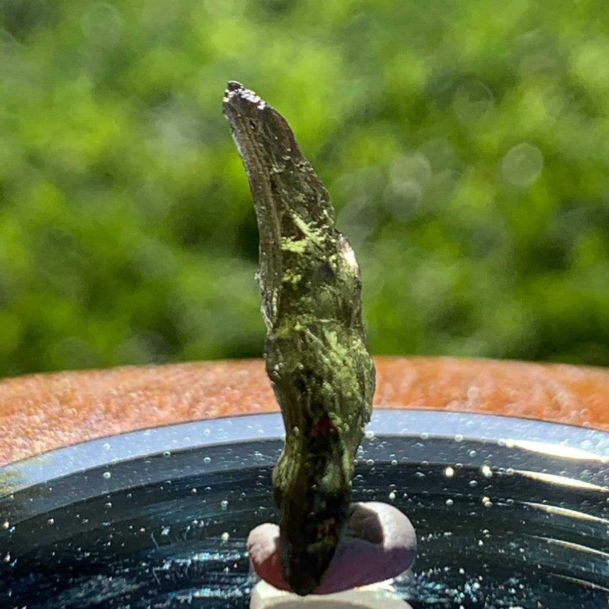 thin green besednice moldavite tektite on display