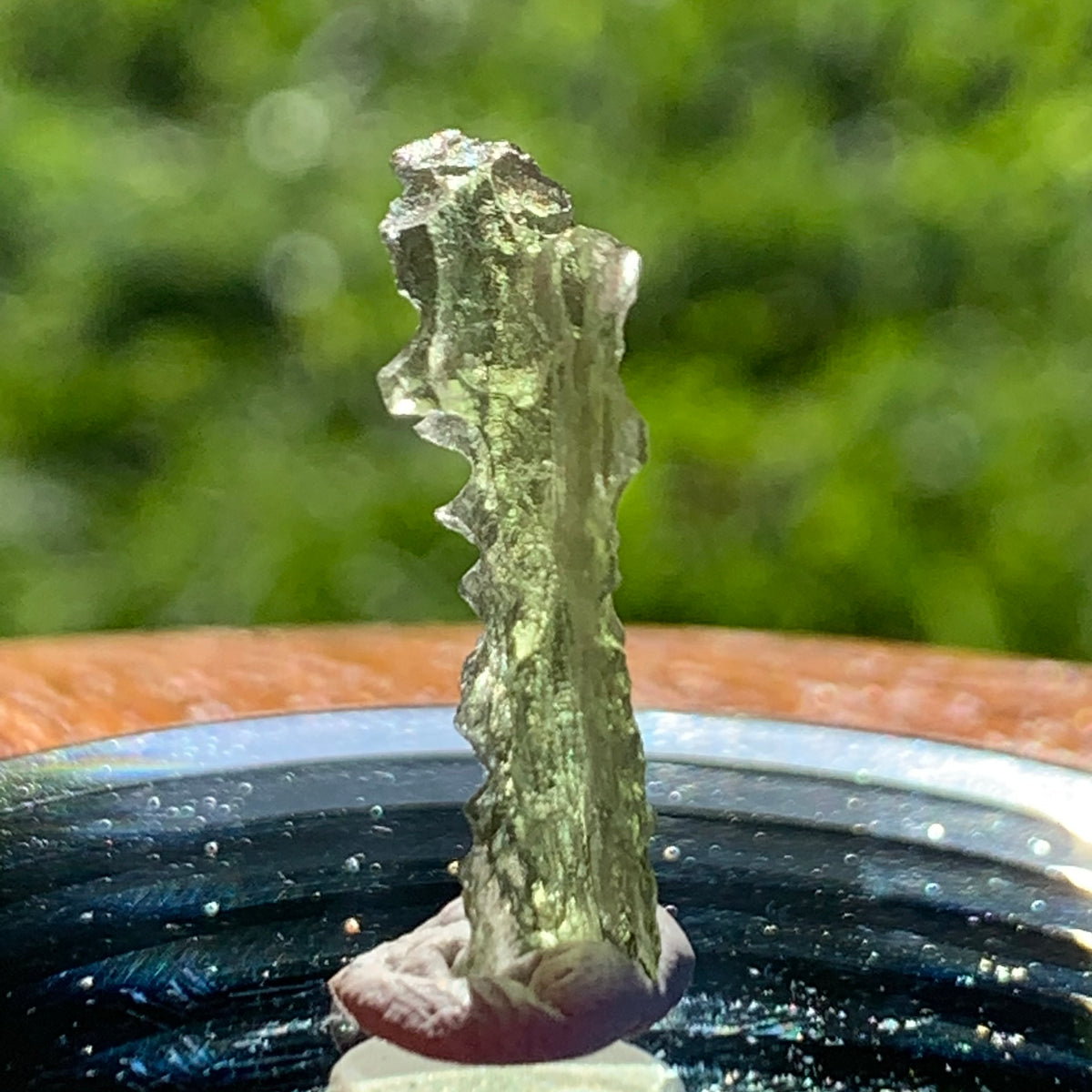 thin green besednice moldavite tektite on display