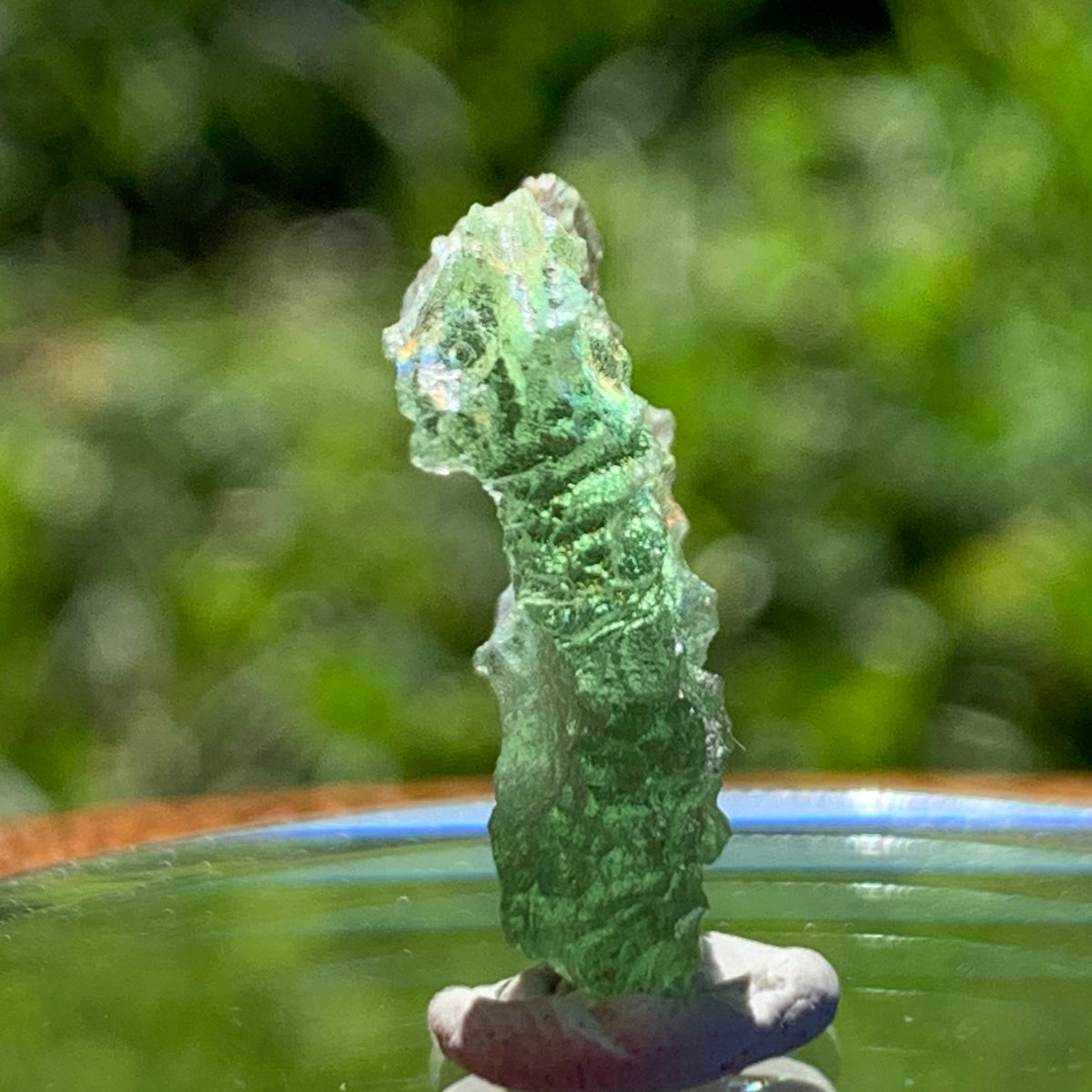 thin green besednice moldavite tektite on display