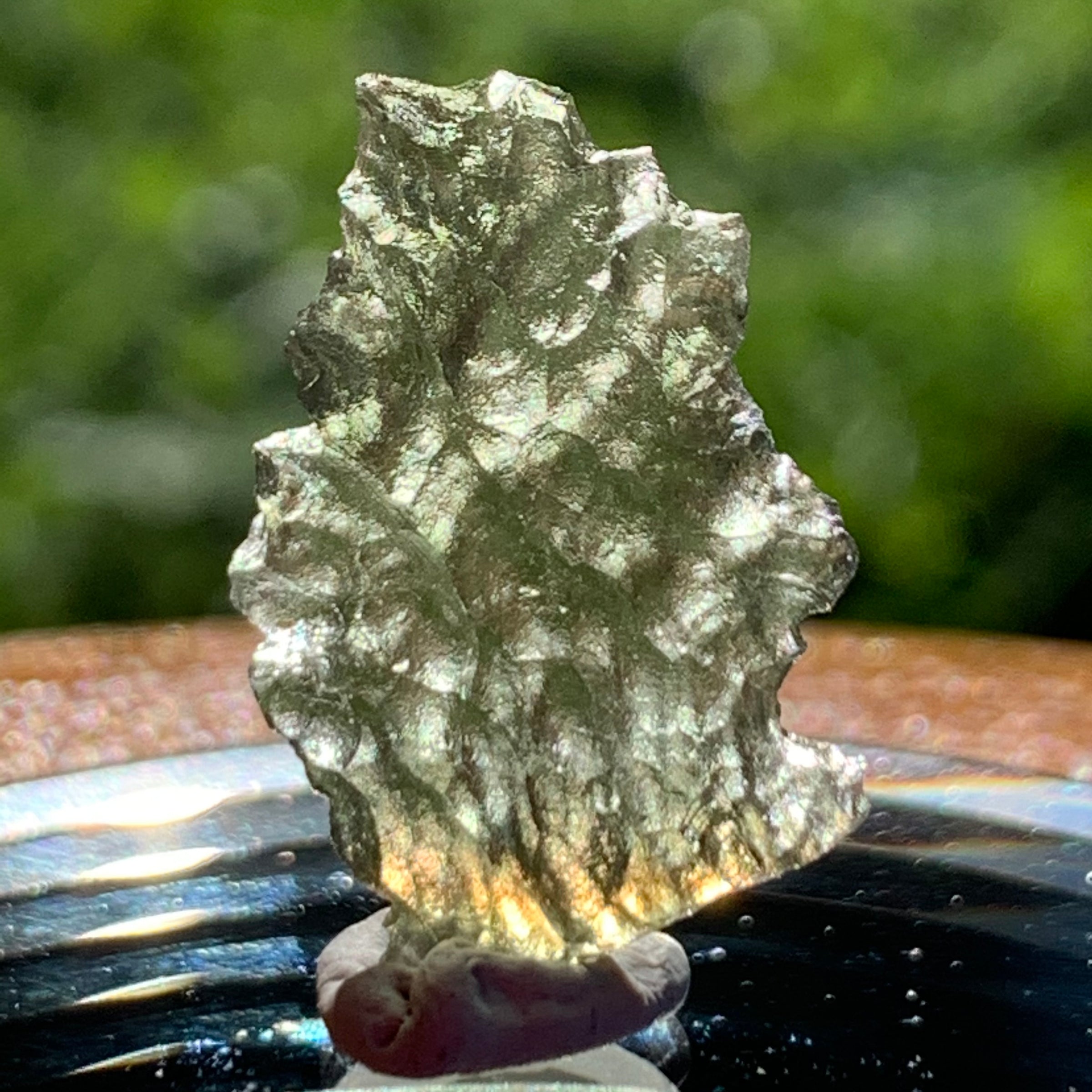 thin green besednice moldavite tektite on display