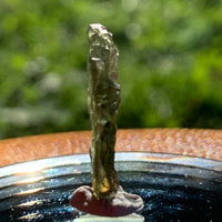 thin green besednice moldavite tektite on display