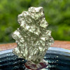 thin green besednice moldavite tektite on display