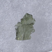 thin green besednice moldavite tektite on display