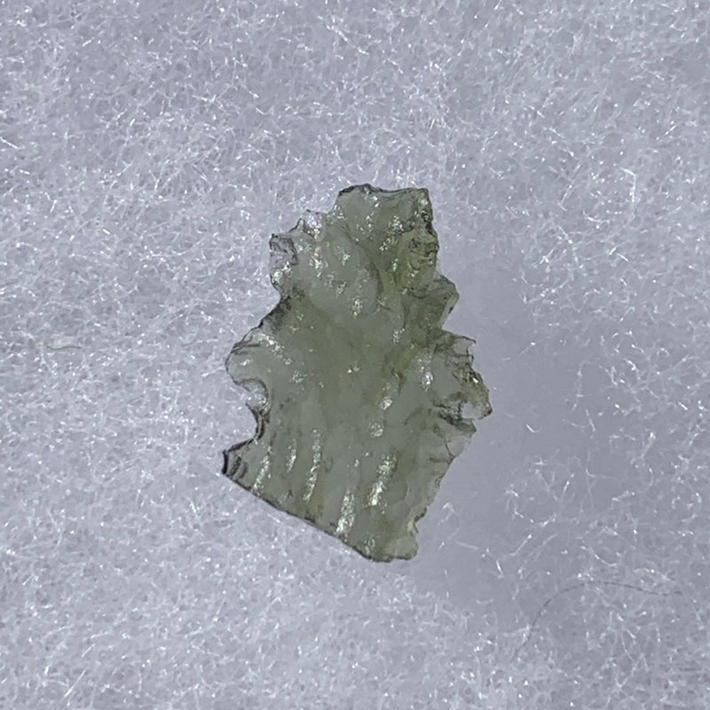 thin green besednice moldavite tektite on display