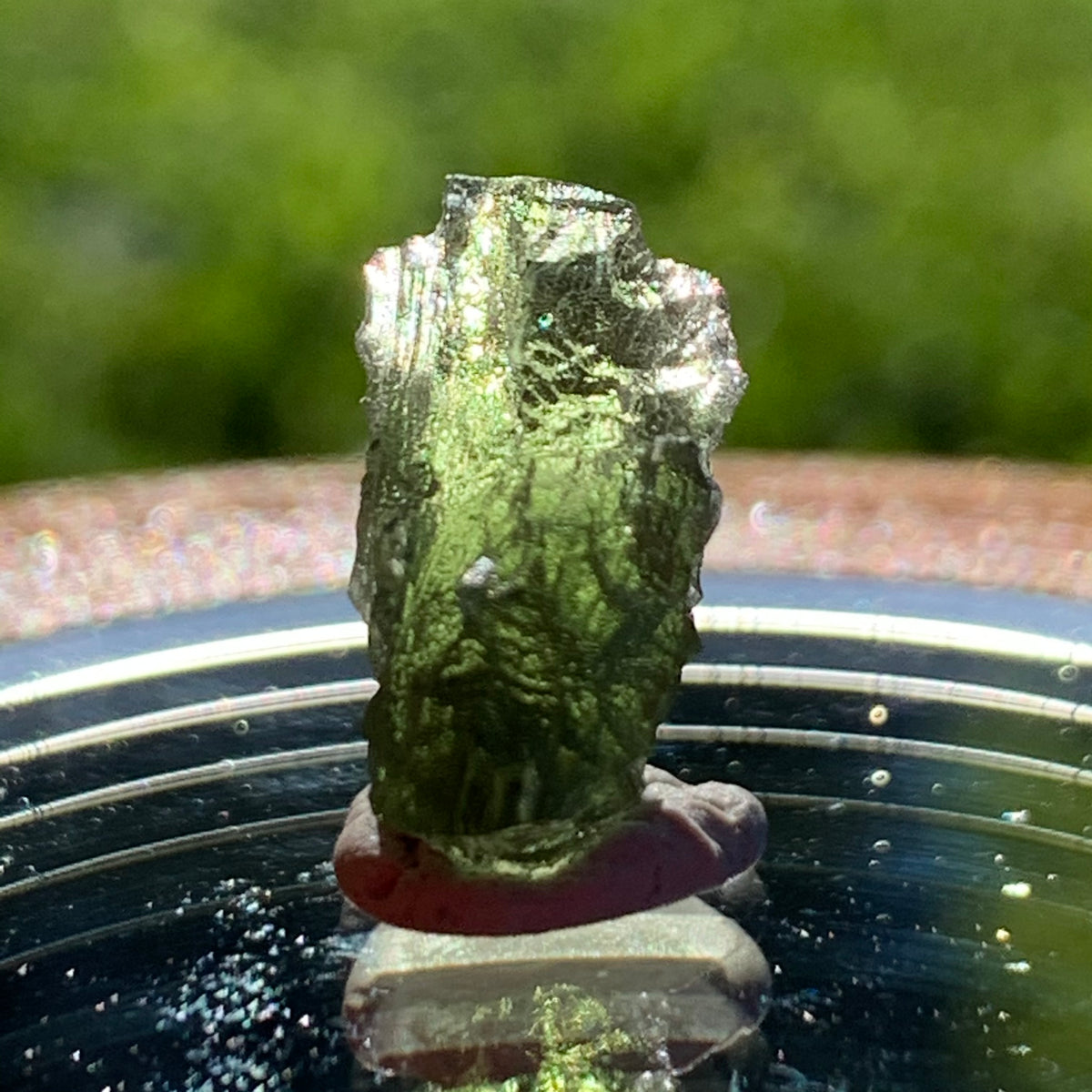 thin green besednice moldavite tektite on display