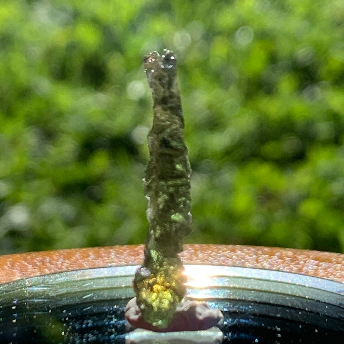 thin green besednice moldavite tektite on display