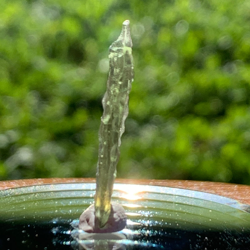 thin green besednice moldavite tektite on display