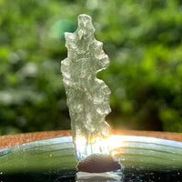 thin green besednice moldavite tektite on display