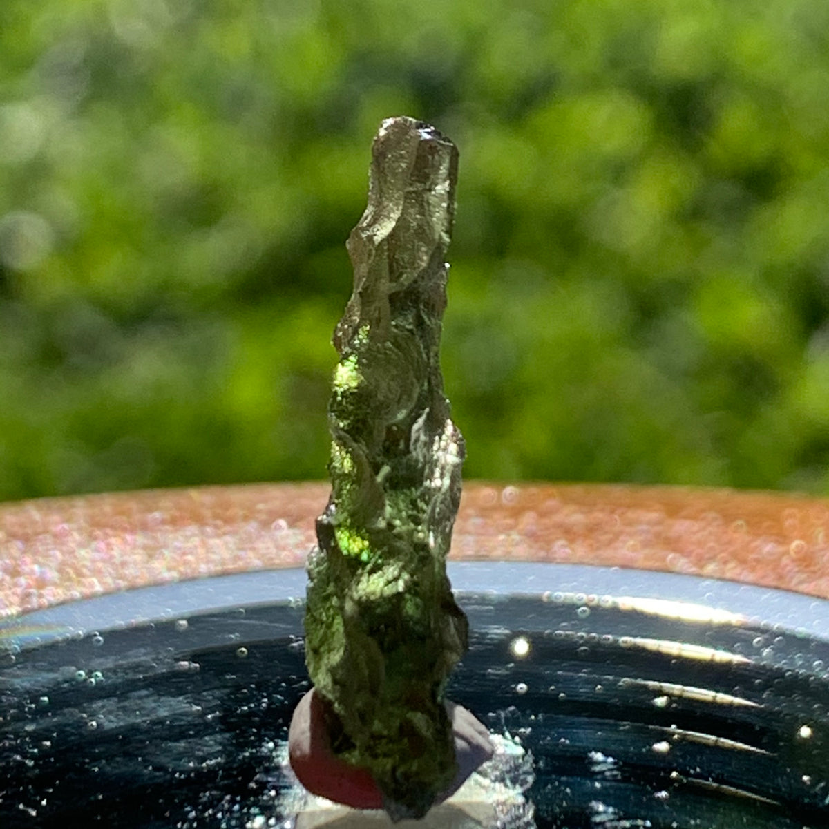 thin green besednice moldavite tektite on display