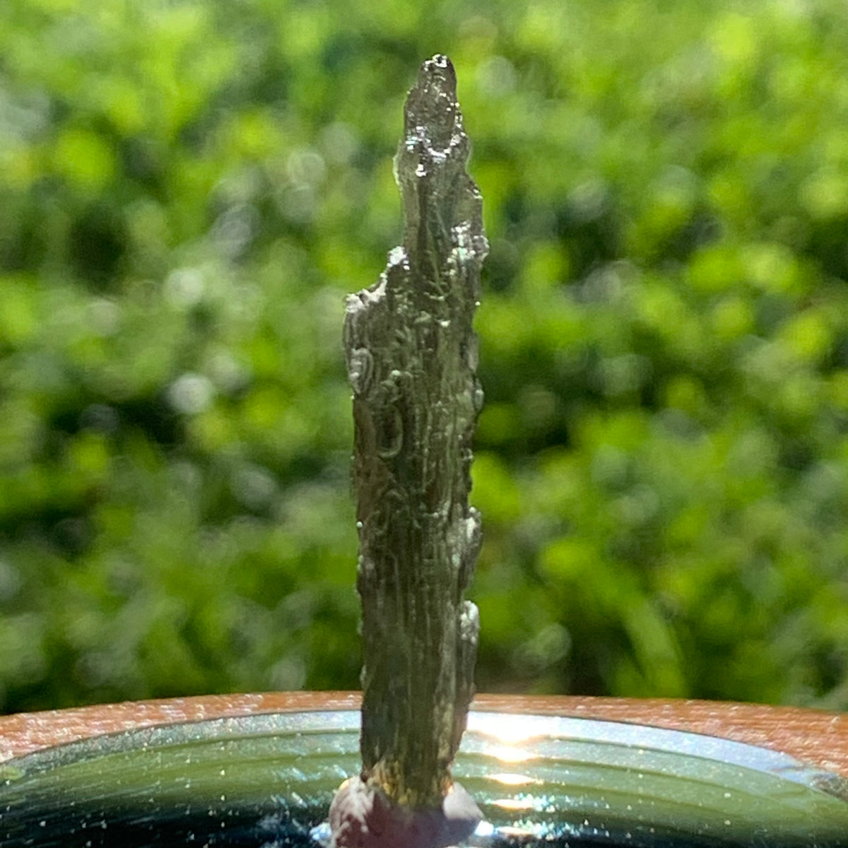 thin green besednice moldavite tektite on display