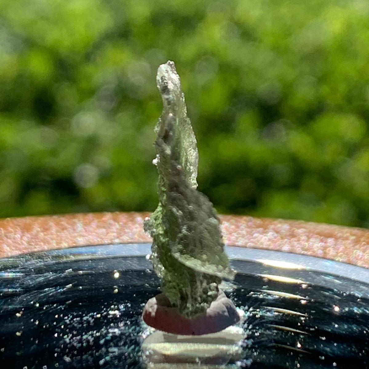 thin green besednice moldavite tektite on display