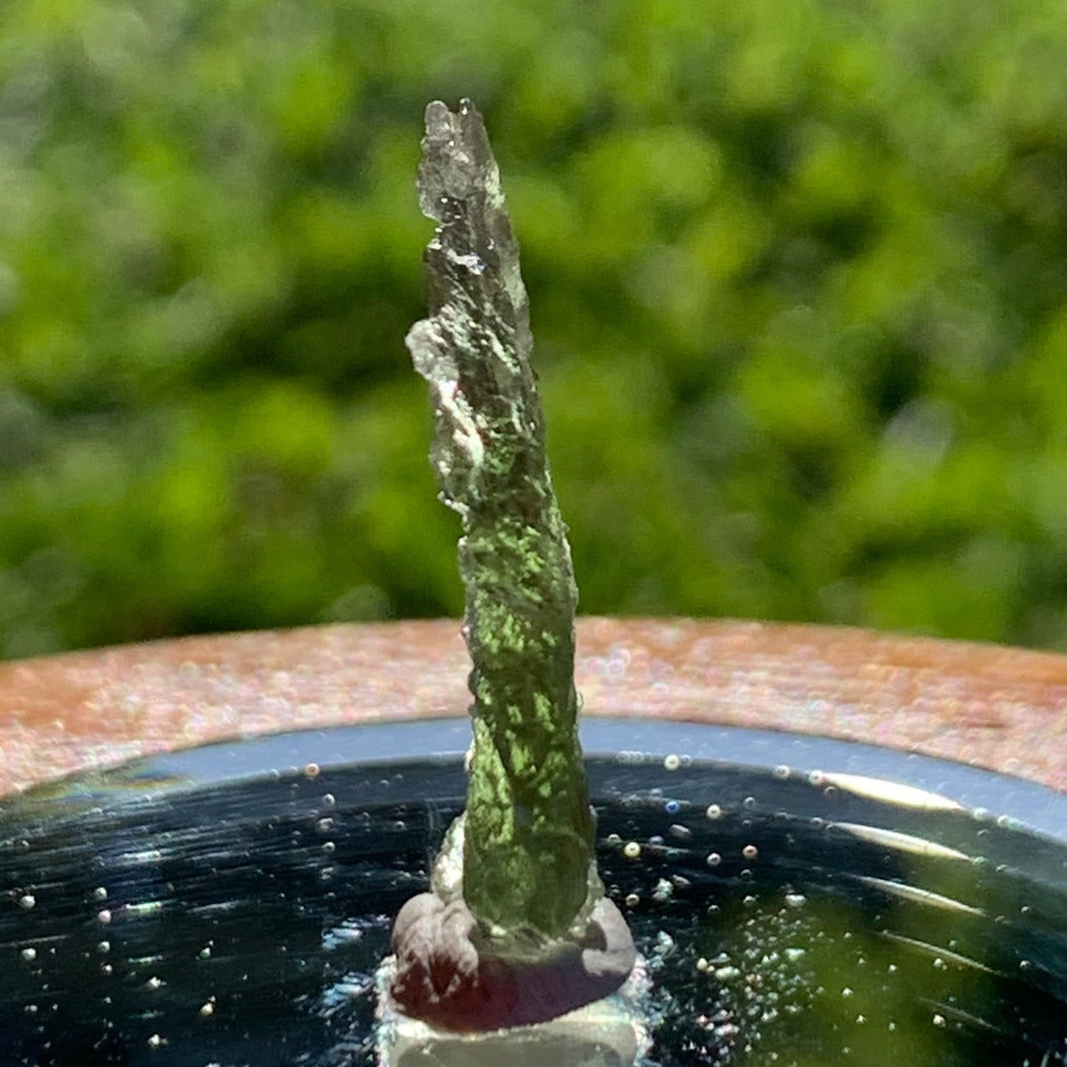 thin green besednice moldavite tektite on display