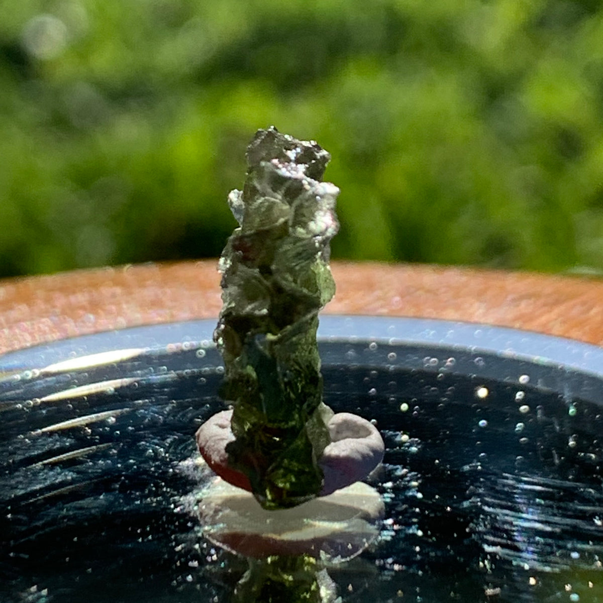 thin green besednice moldavite tektite on display