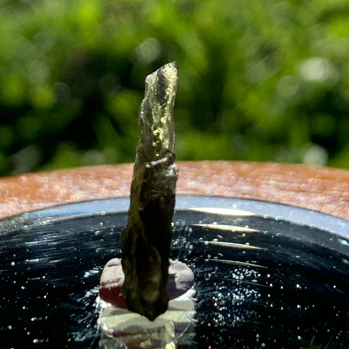 thin green besednice moldavite tektite on display