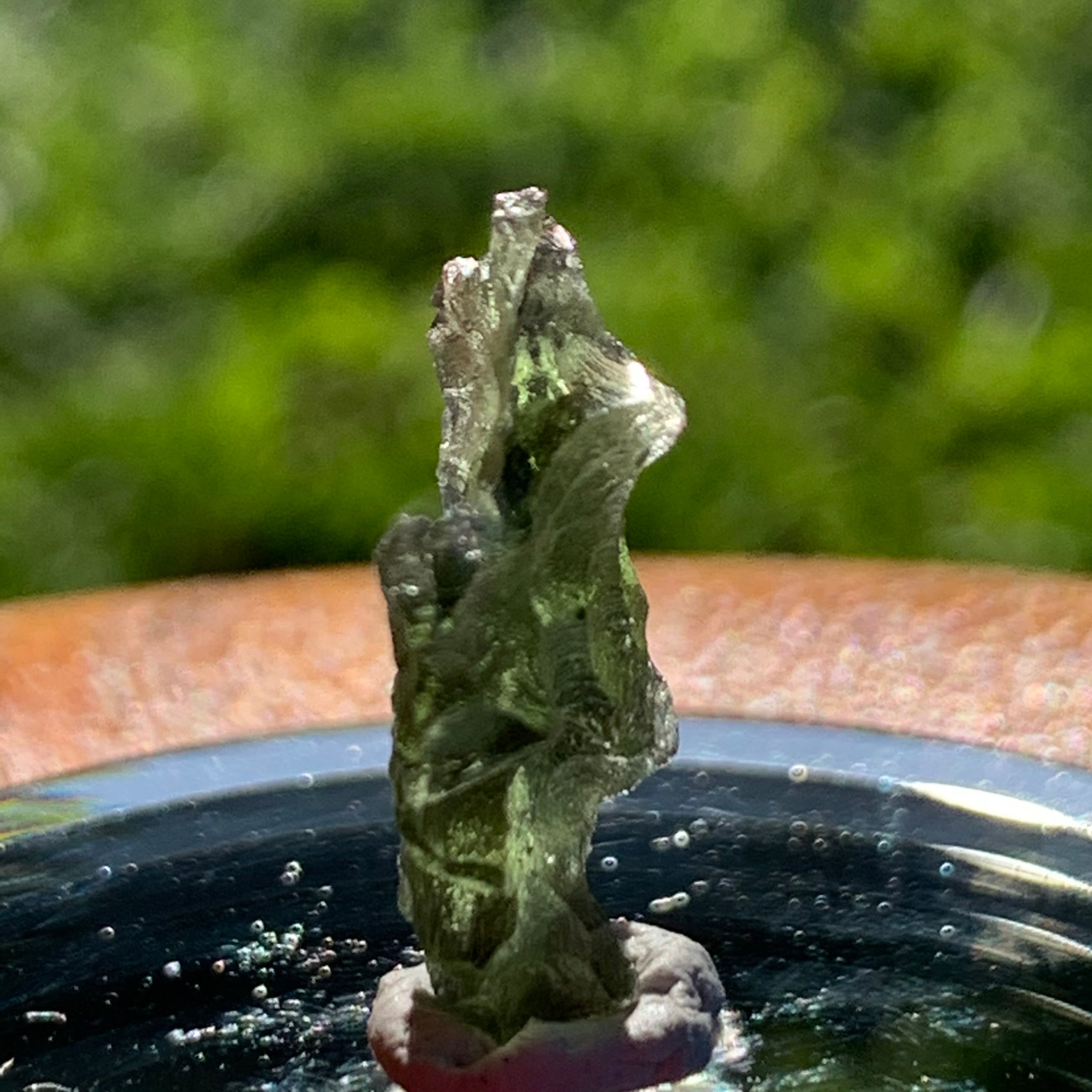 thin green besednice moldavite tektite on display