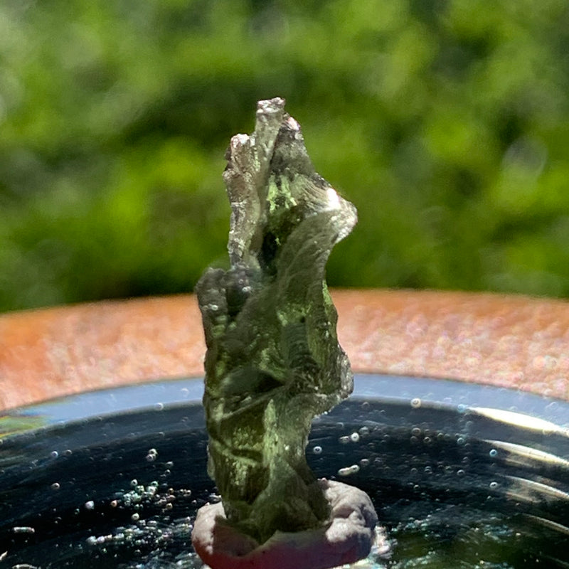 thin green besednice moldavite tektite on display