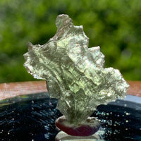 thin green besednice moldavite tektite on display