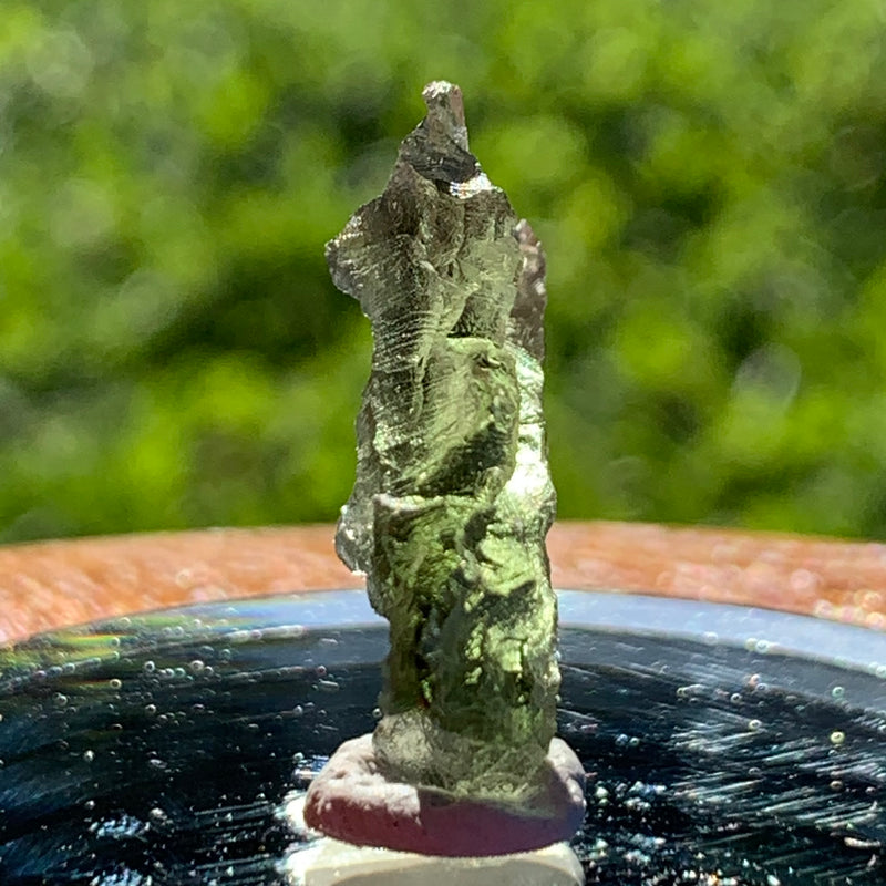 thin green besednice moldavite tektite on display