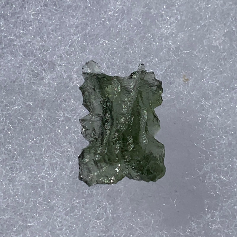 thin green besednice moldavite tektite on display