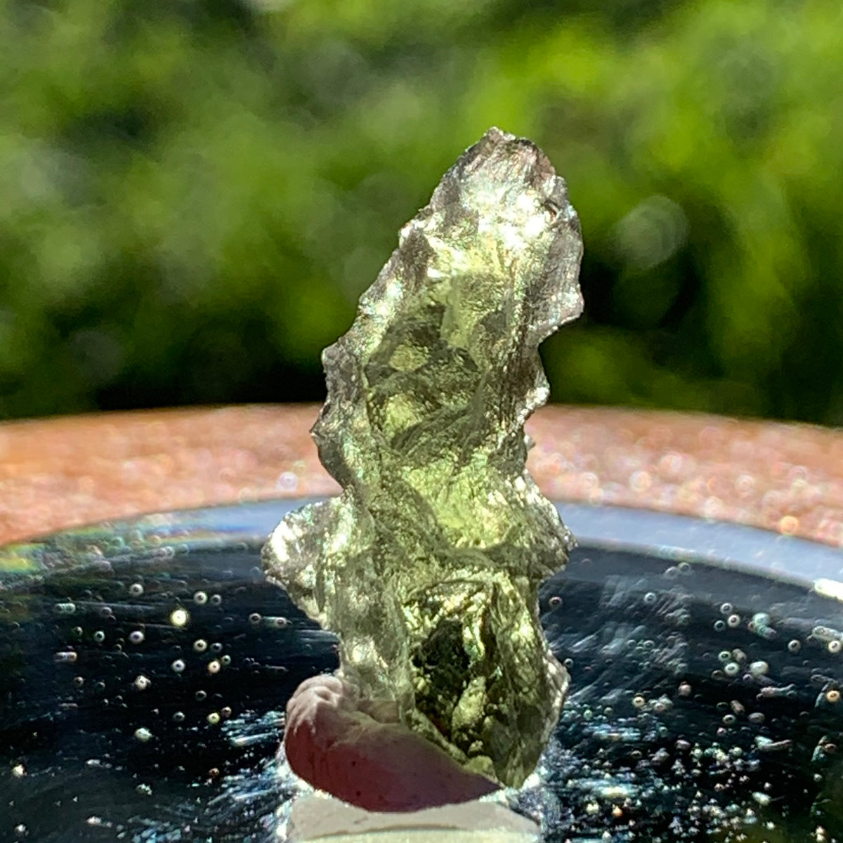 thin green besednice moldavite tektite on display