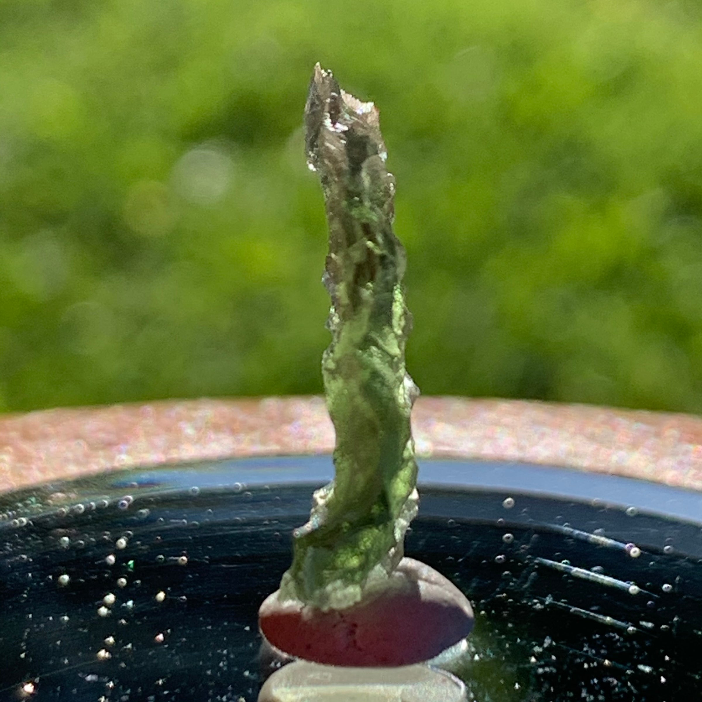 thin green besednice moldavite tektite on display